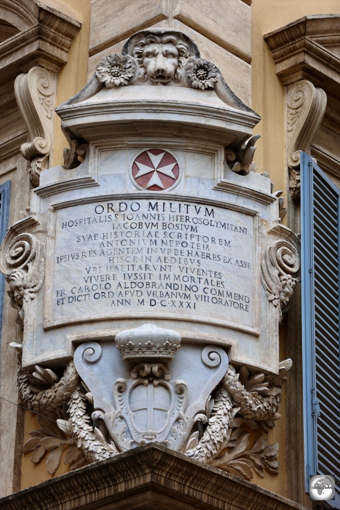 A marble plaque on the outside of the Magistral Palace, on the corner of Via dei Condotti and Via Boca di Leone.