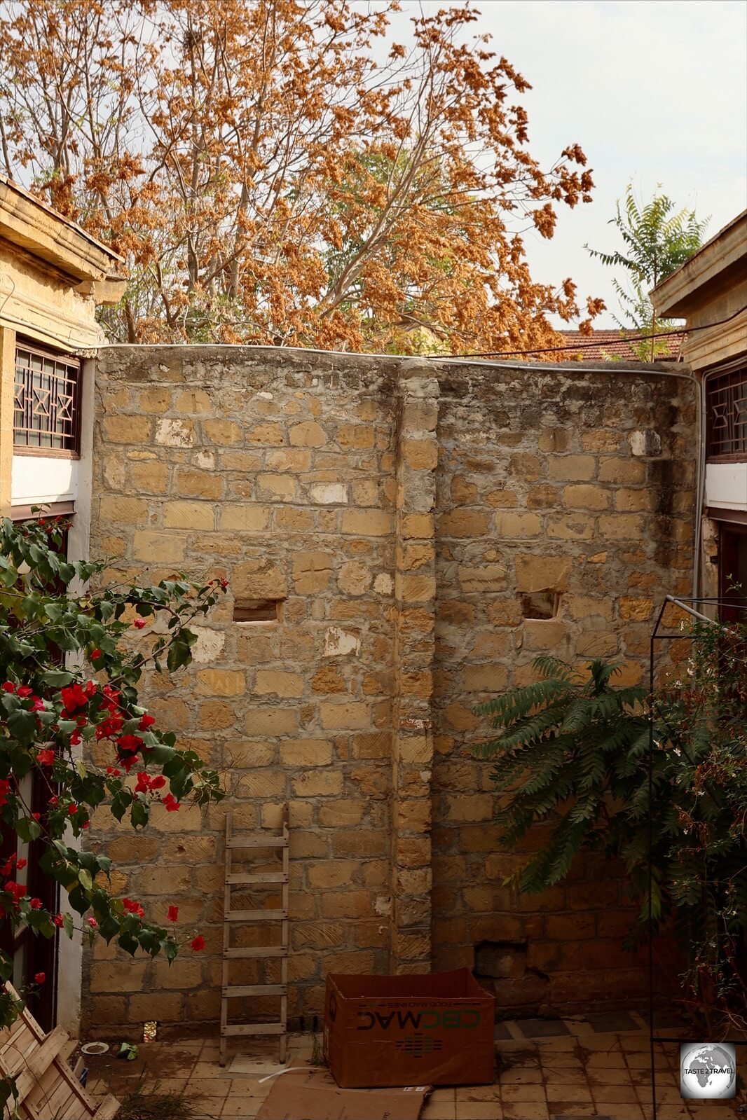 A laneway in North Nicosia is blocked by a section of wall which includes a ladder and two peep holes.