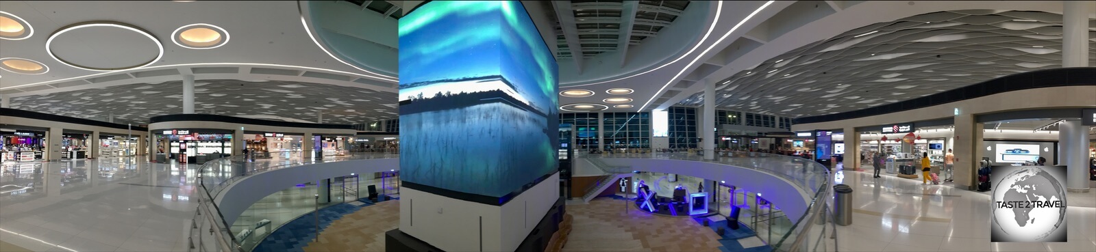 A large LED screen in the centre of the terminal screens 'Bahrain Moments'.