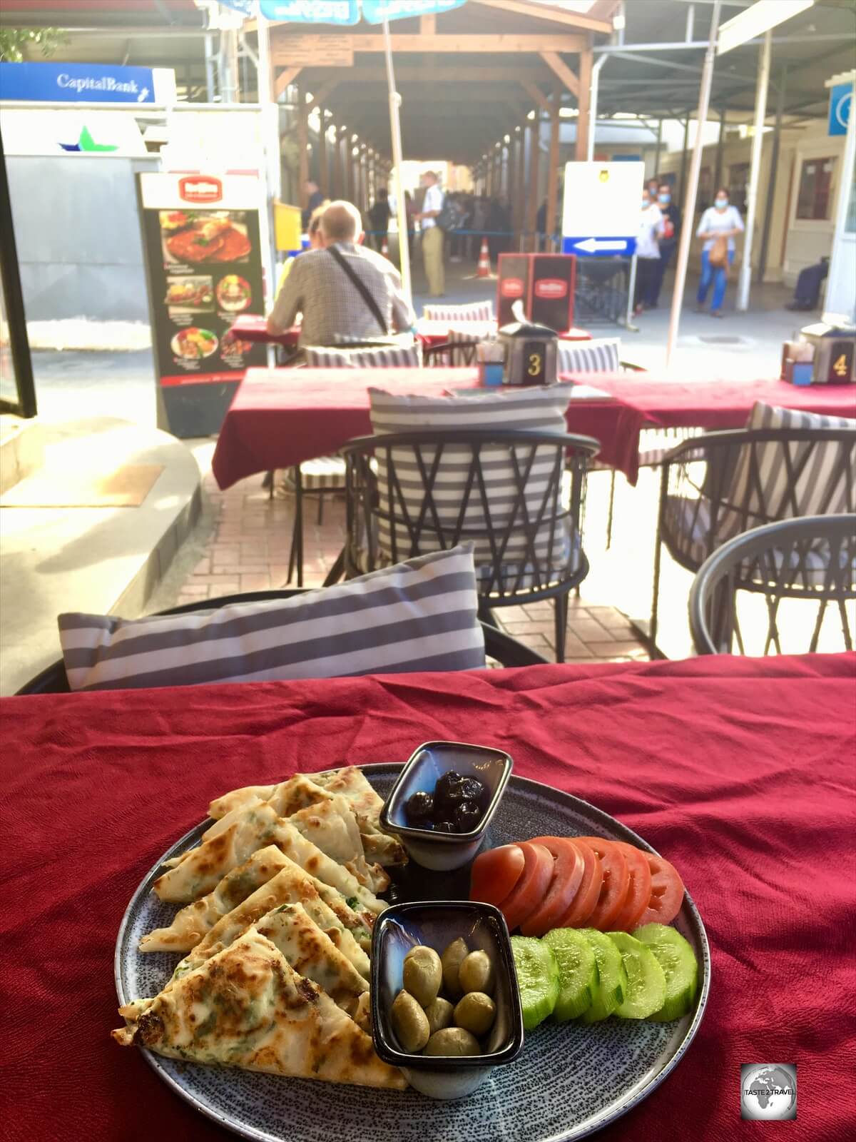 A grilled halloumi sandwich for lunch at Simit Dünyası in North Nicosia, with the TRNC checkpoint in the background.