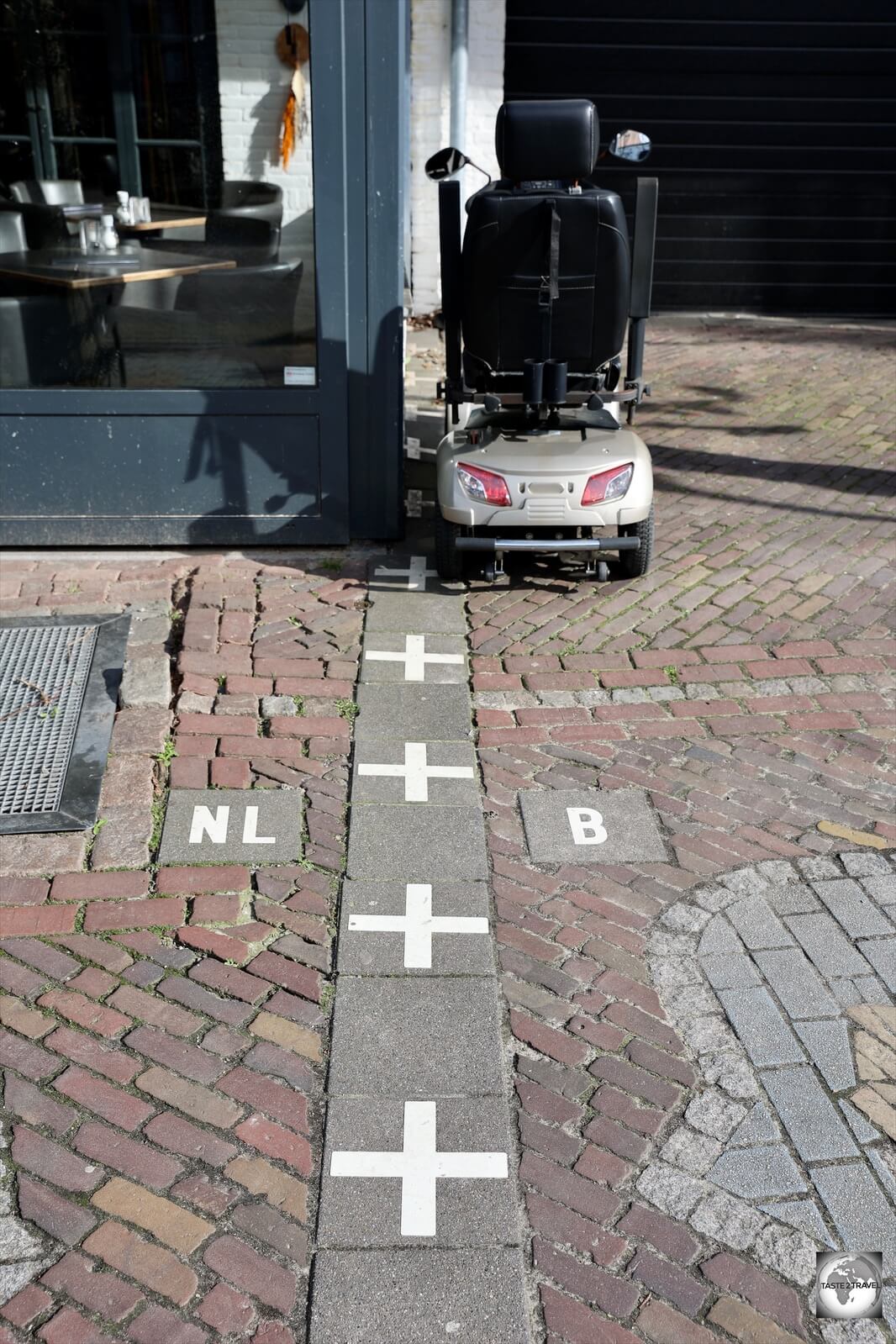 A border marker on the main square, outside 'Den Engel' brasserie.