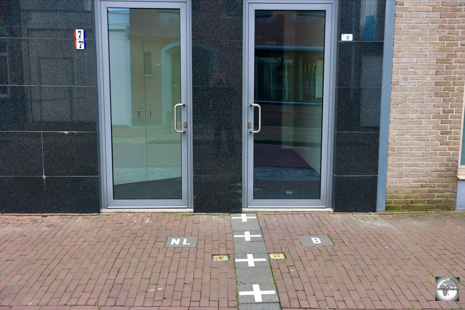The owner of this apartment building skirted a Dutch building restriction by installing a second front door on the Belgian side of the border.
