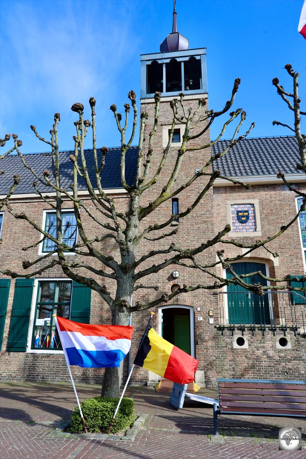 The tourist office in downtown Baarle flies the flags of Belgium and the Netherlands.