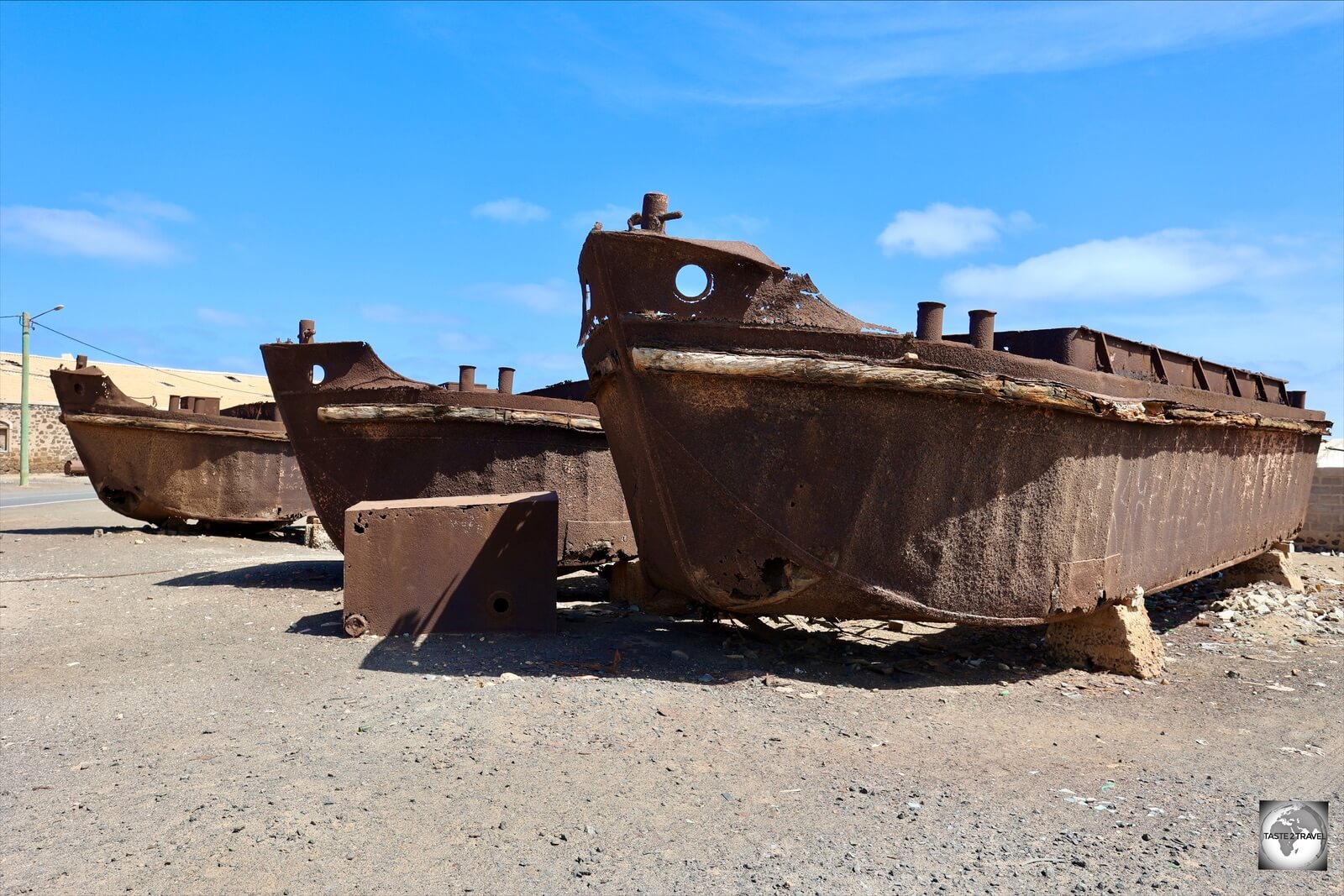 The slowly decaying, rusted hulks of former salt barges, in a boat graveyard at Pedra de Lume.
