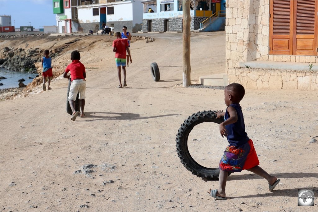 Young boys rolling tyres in Sal Rei.