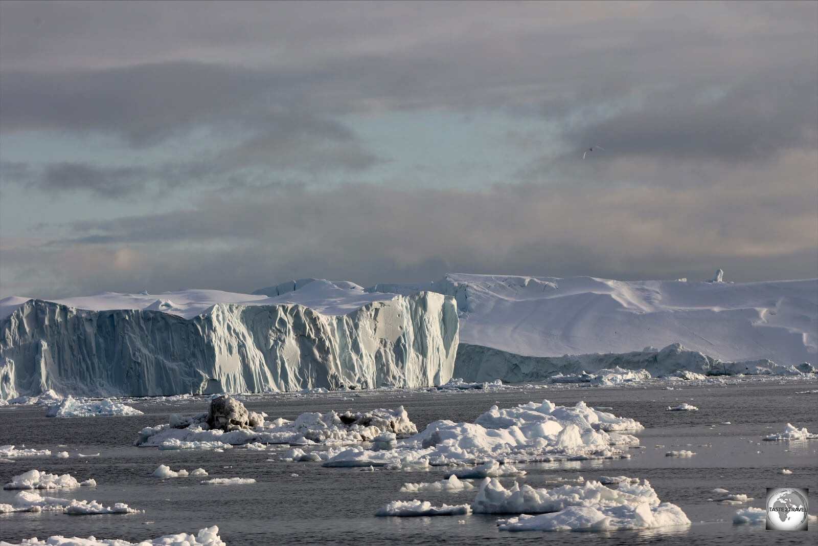 Floating icebergs, the size of mountains, slowly move into the sea from the Ilulissat Ice Fjord. Perilous obstacles for any ship!