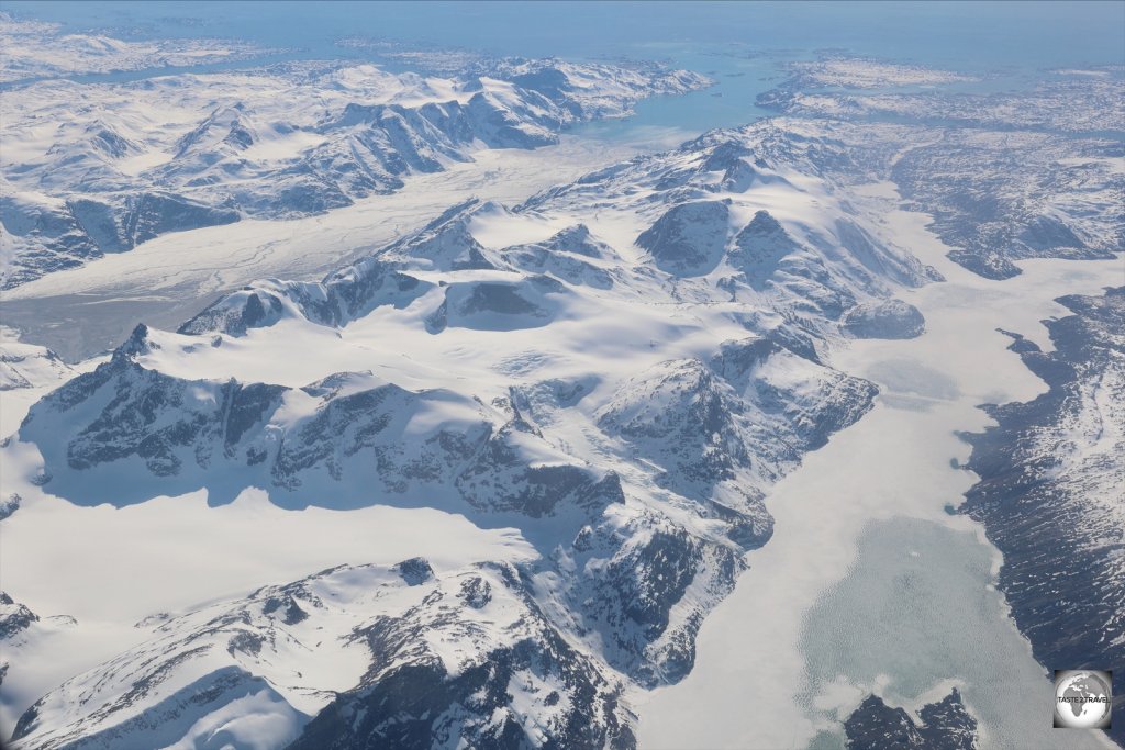 Flying over the Greenland Ice Sheet, with a view of two glaciers which drain the ice sheet at the coastal periphery.