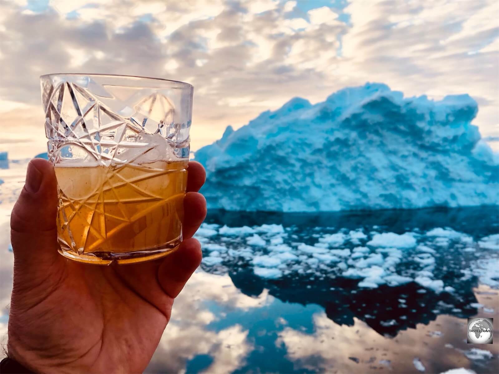 A gin cocktail with a chunk of glacier ice is a highlight of a Disko Line Icefjord cruise.