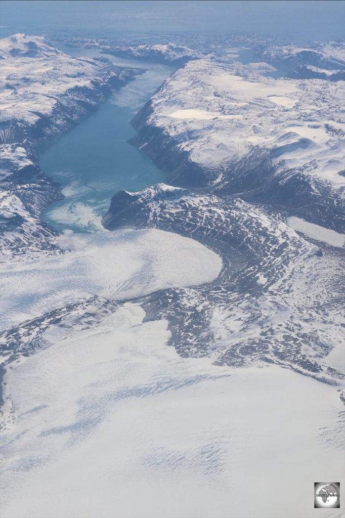 The Greenland Ice Sheet is drained along the coast by many massive glaciers.