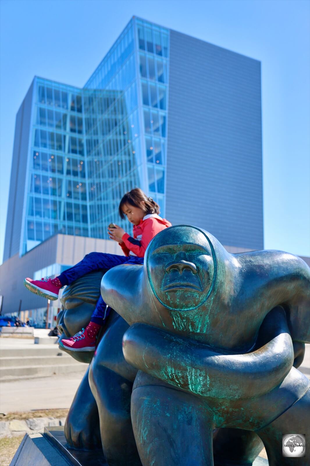 A statue in Nuuk provides the perfect resting place for a young Inuit girl.