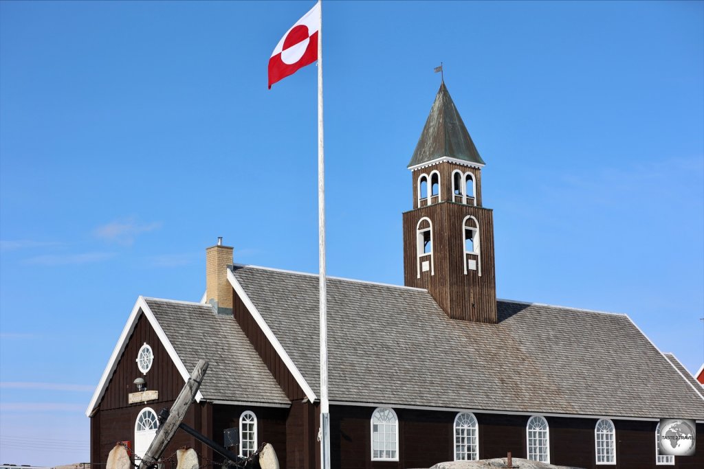 The flag of Greenland flying alongside Zion's church in Ilulissat.