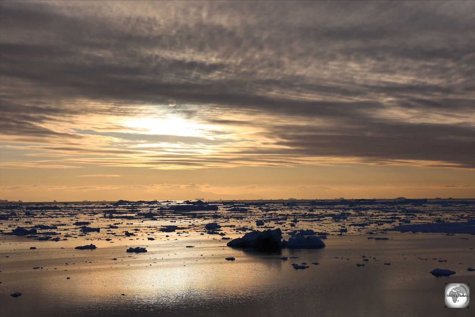 The midnight sun, which never sets, over an iceberg-filled Disko Bay, Ilulissat.