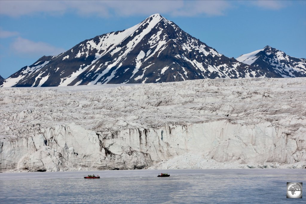 Two zodiac boats provide a sense of scale for the huge Esmark glacier, one of hundreds of glaciers on the archipelago.