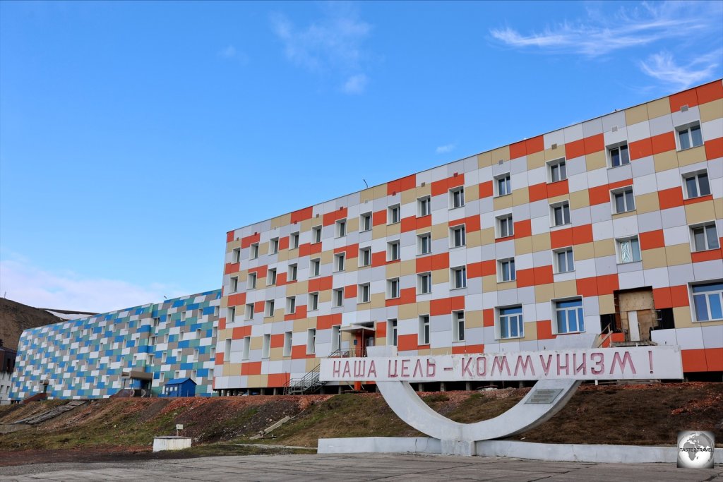 A Soviet-era sign outside a modern apartment building in Barentsburg proclaims "Communism is our goal".