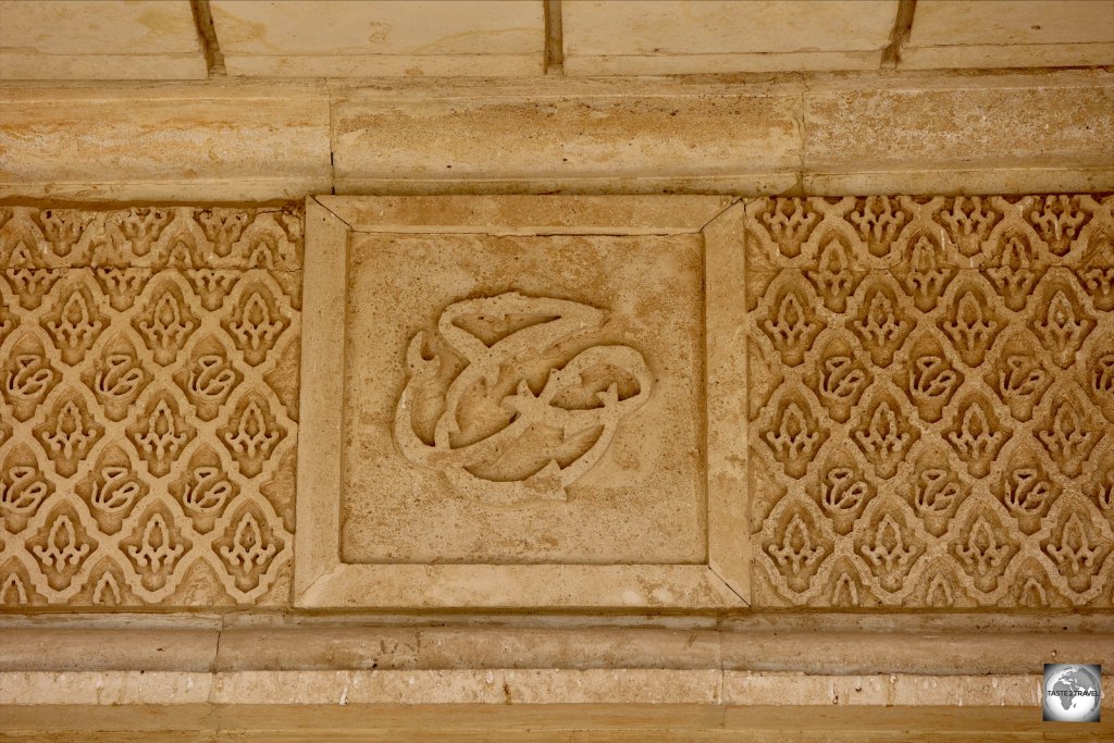 The arabesque initials of Saddam Hussein line the exterior walls of the palace.