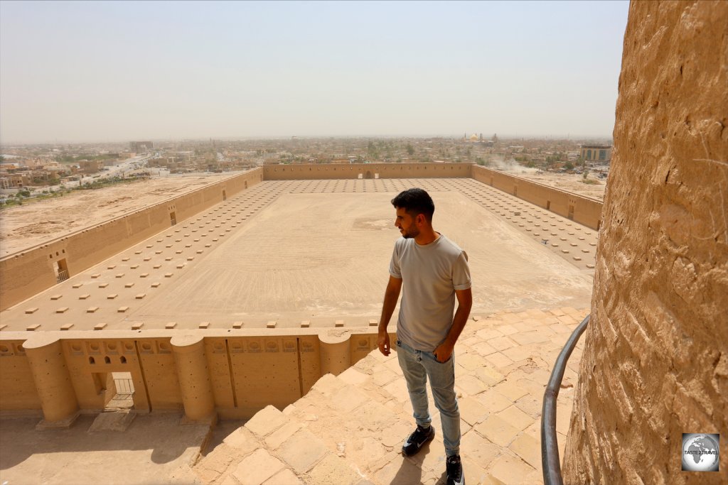 My guide Fahad, of Iraq Adventures, on top of the Malwiya minaret, with the Great Mosque of Samarra in the background.