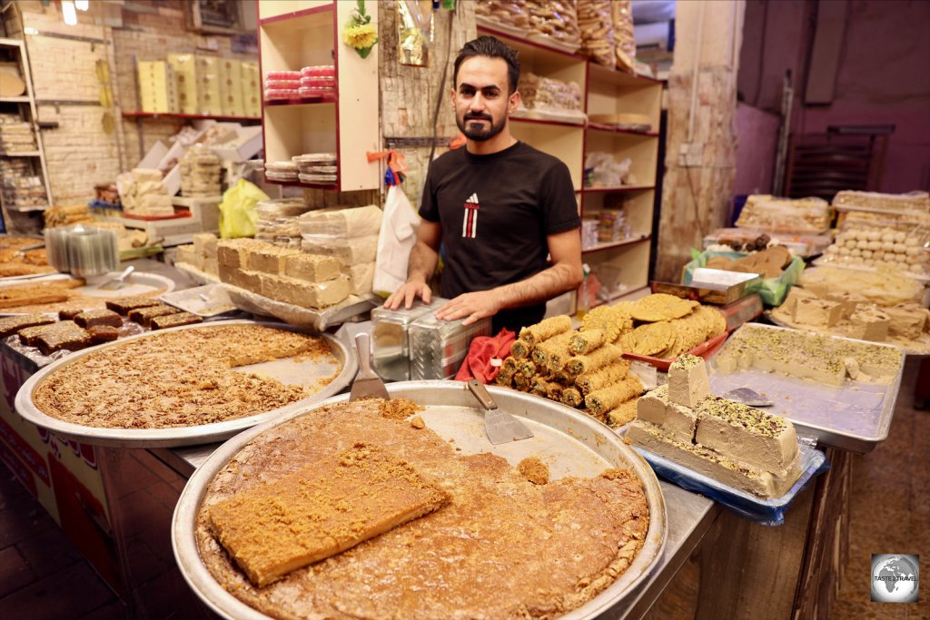 A vendor at Najaf souk, selling trays of sweet and delicious "Halva Dehin Najaf".