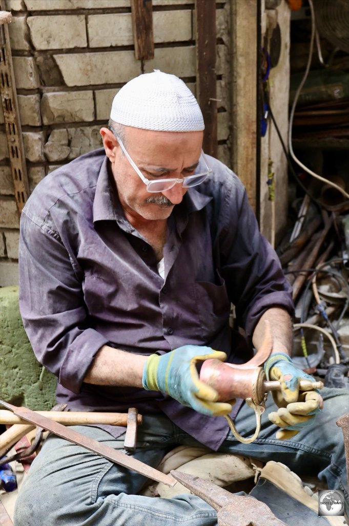 Copper artisan in the Al-Safafeer souk, Baghdad.