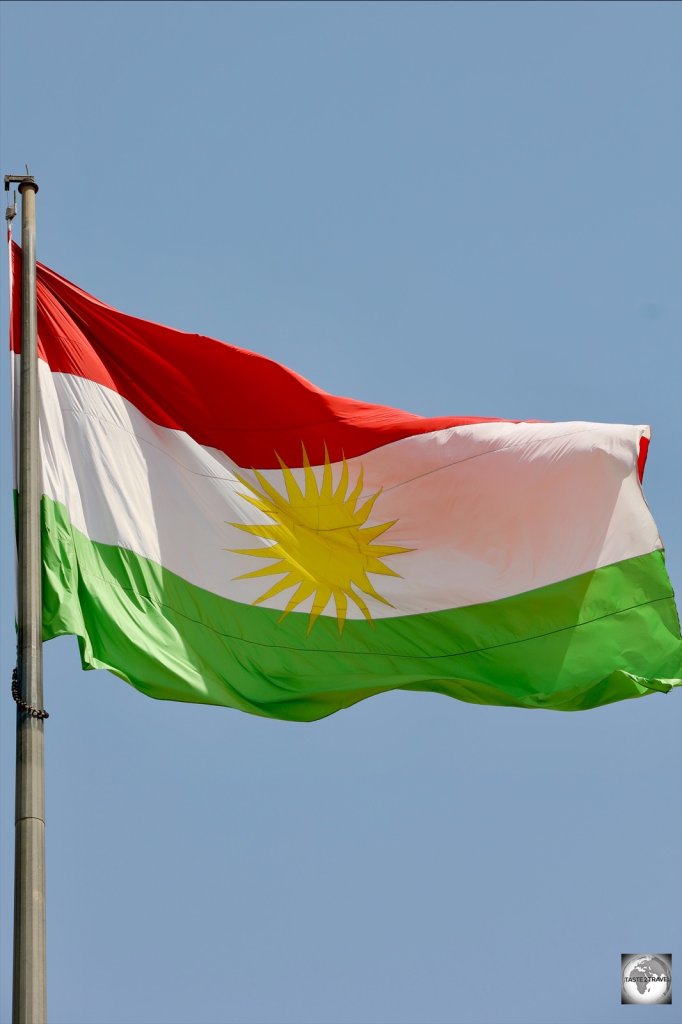 The flag of Kurdistan, flying over Erbil citadel.