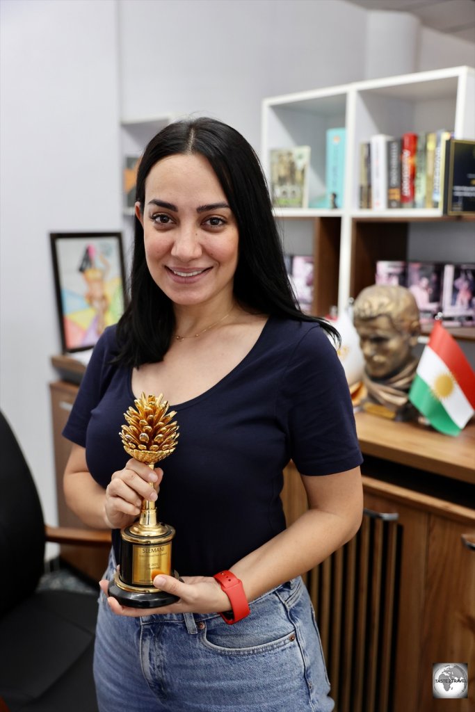 Lina Raza, displaying the Golden Pine Cone which is awarded at the Slemani International Film Festival.