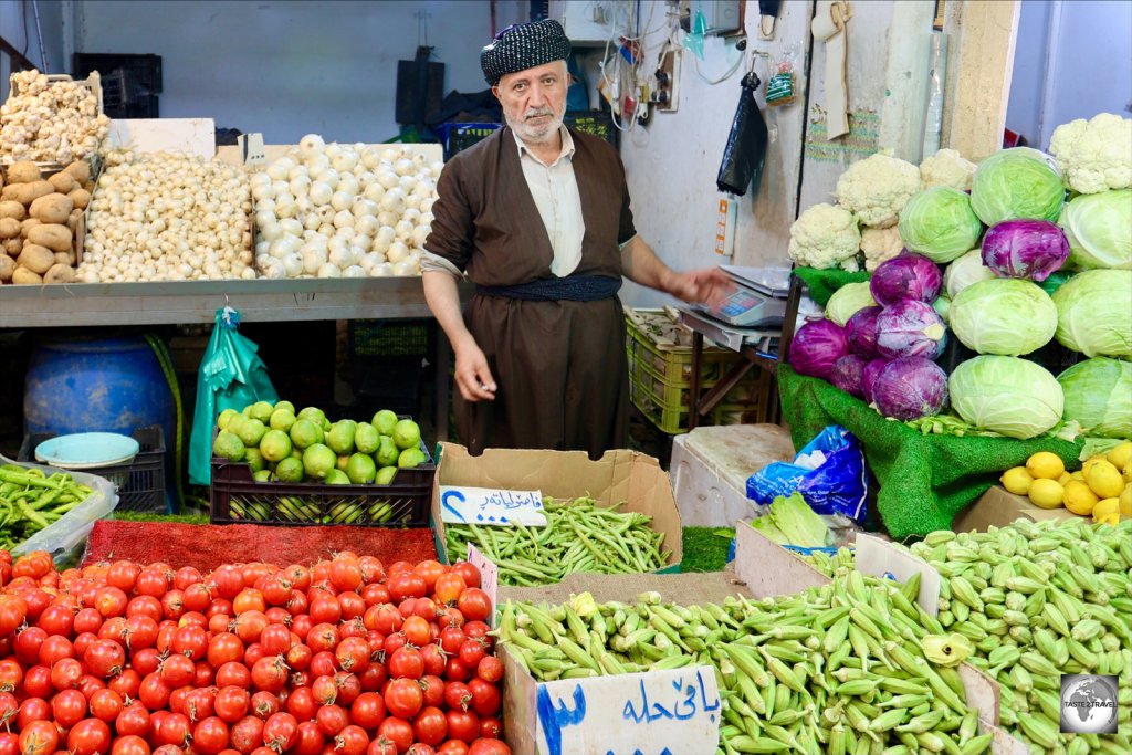Produce vendor at Sulaimaniyah souk.