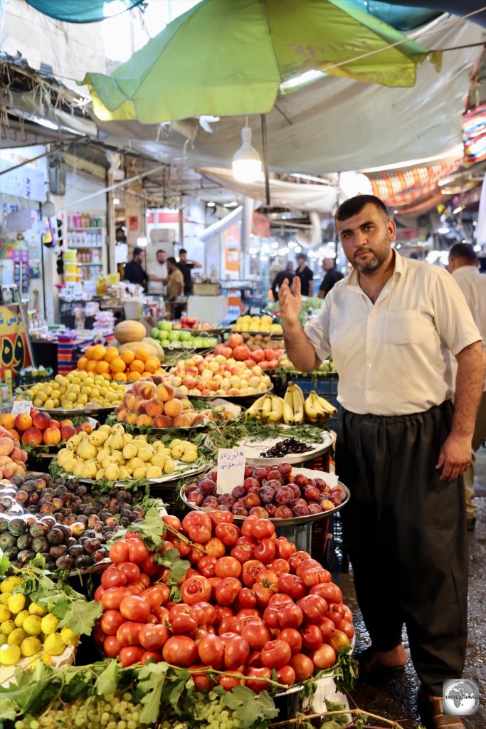 A produce vendor in Sulaimaniyah souk.