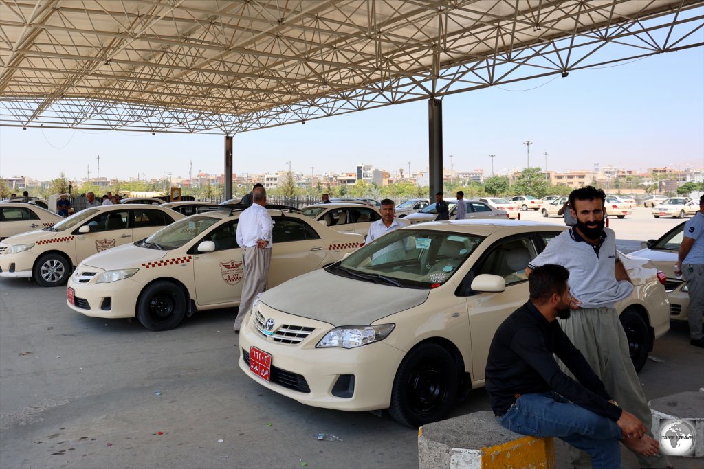 Long-distance shared taxis waiting at Sulaimaniyah taxi station.