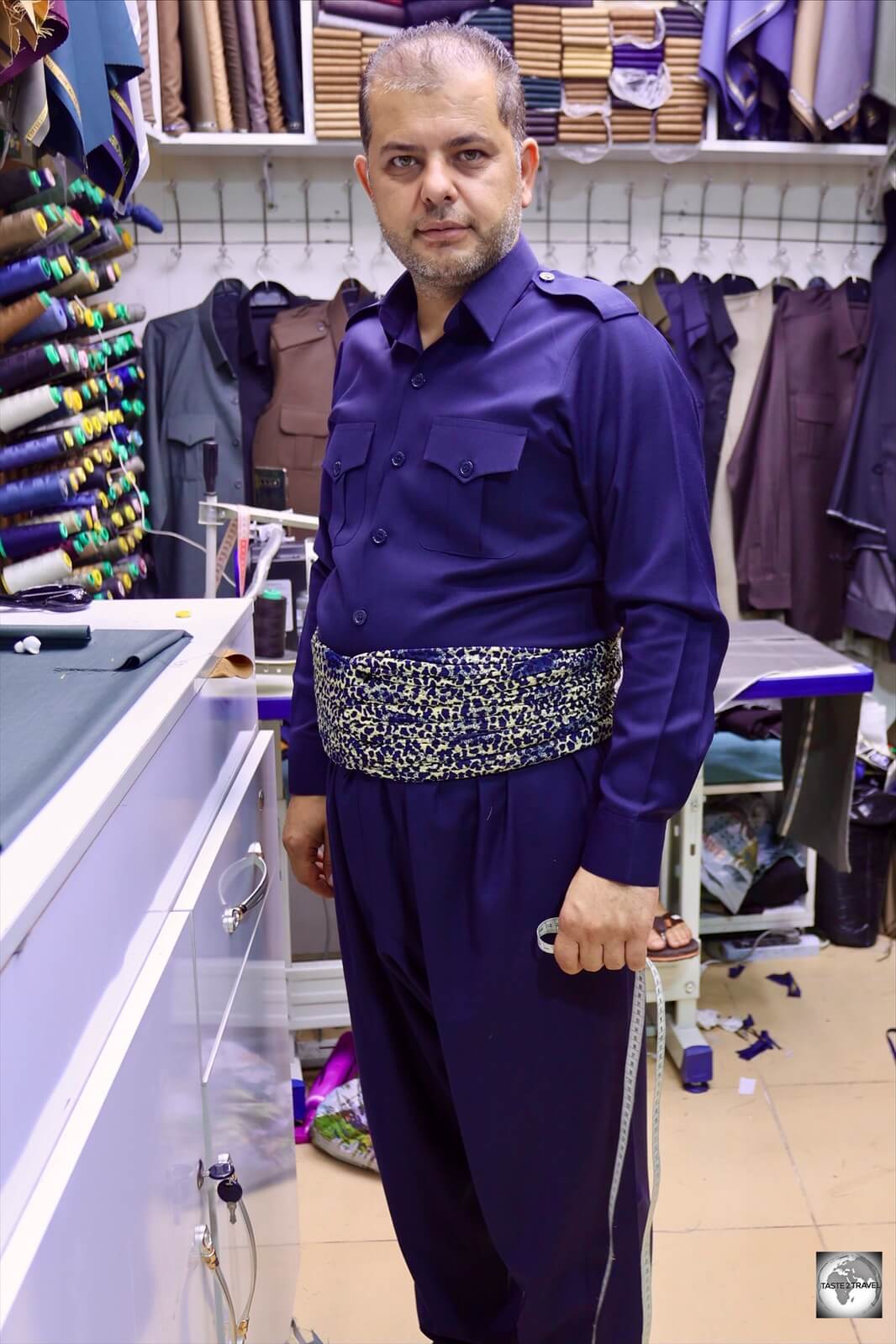 A Kurdish tailor at Erbil market, wearing traditional clothing.