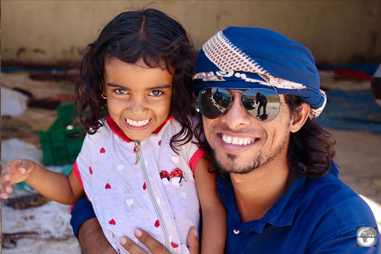 My guide Ali, posing with the very cute daughter of a friend, in the town of Qalansiya.
