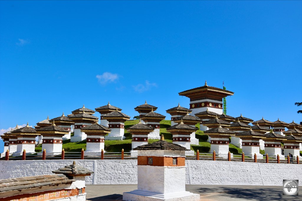 The Druk Wangyal Chortens are built on a grassy mound which forms a roundabout in the middle of the highway.