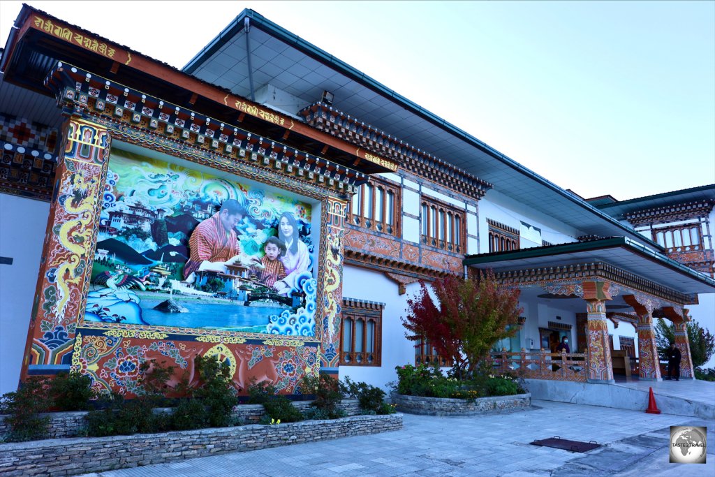 A view of the terminal at Paro International Airport, with a mural featuring the King and Queen of Bhutan and their son., Prince Jigme Namgyel Wangchuck.