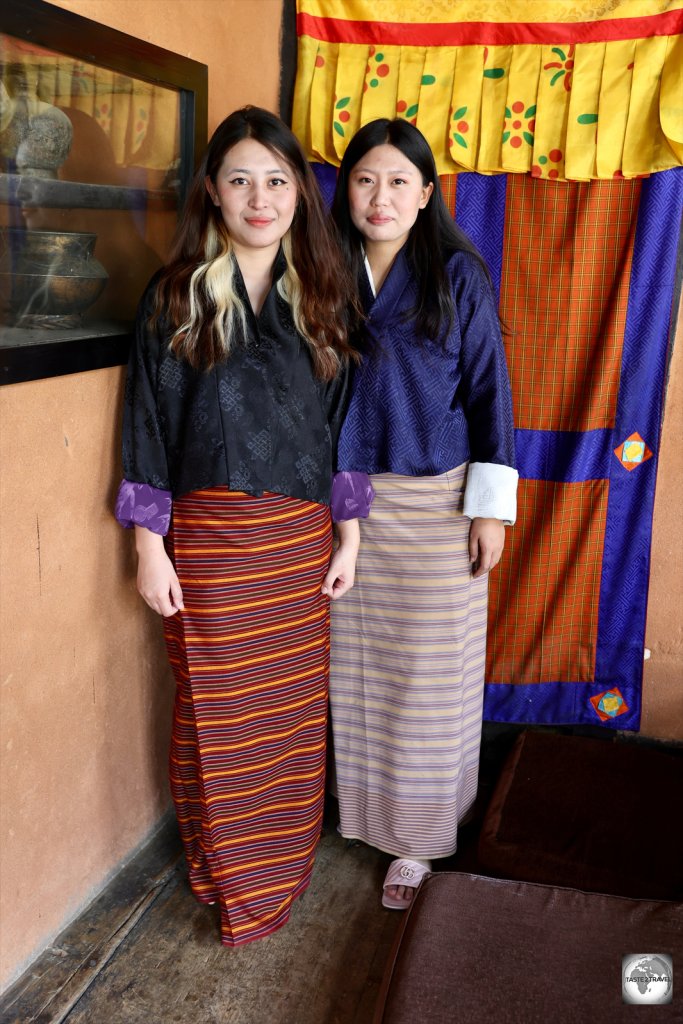 Two women at the Babesa restaurant in Thimphu wearing traditional dress.