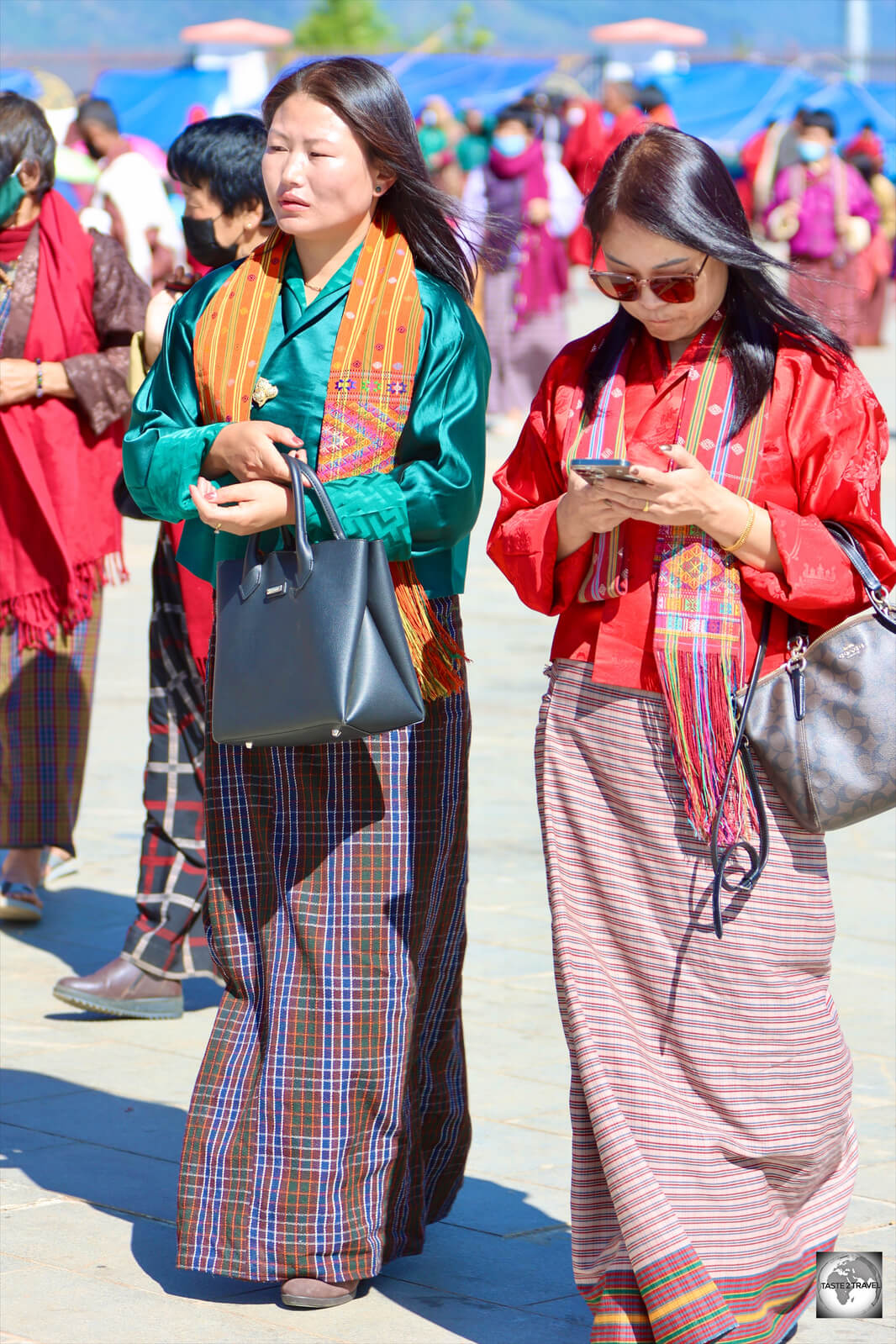 Two women at the Buddha Dordenma temple wearing traditional dress.