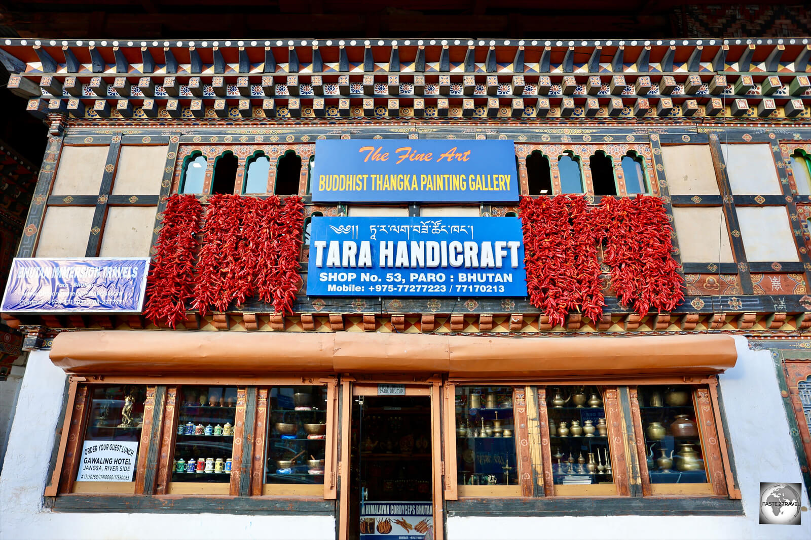 A shop on the main street of Paro. The shopfront is decorated with strands of red chillies.