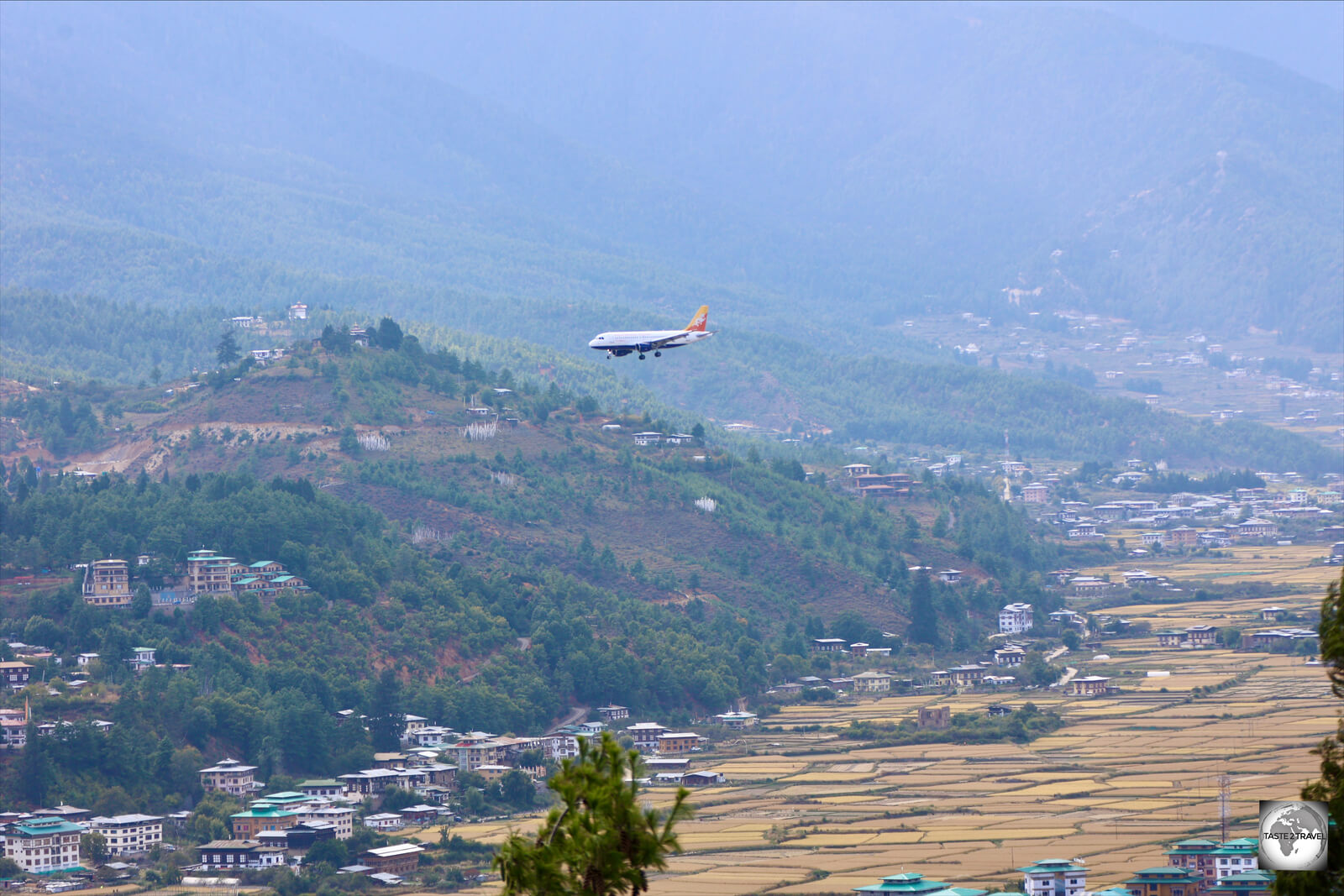 A Druk Air flight, on final approach to Paro International Airport, flying over Paro Valley.