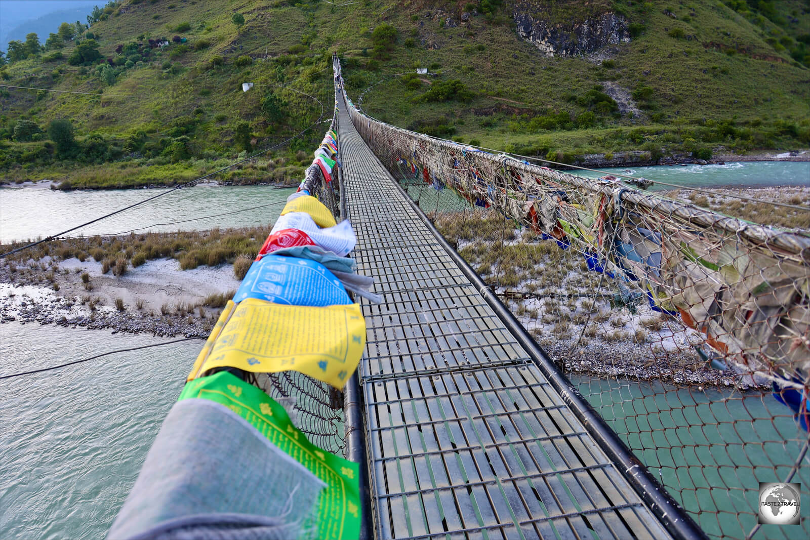 Prayer flags flutter on Punakha suspension bridge - the longest such bridge in Bhutan.
