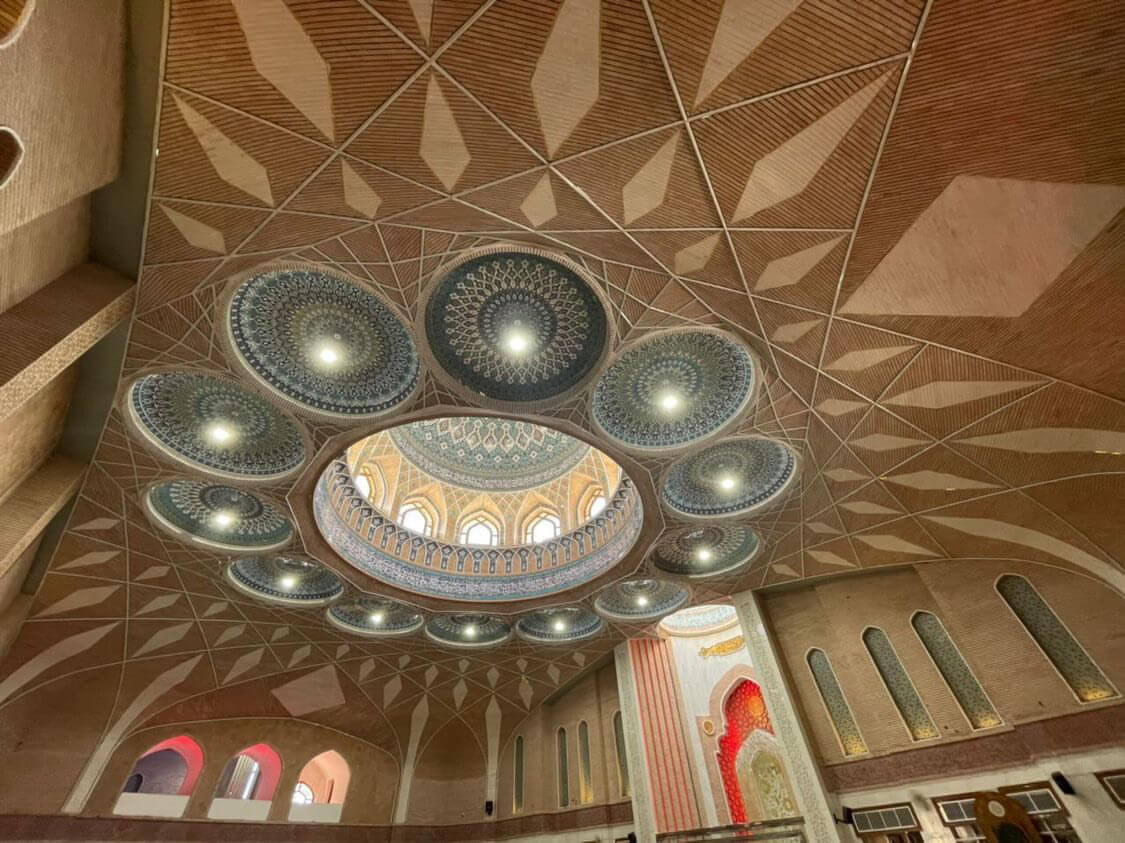 The main tiled dome at Al-Sahlah Mosque is surrounded by 12 smaller tiled domes, representing the 12th Imam.