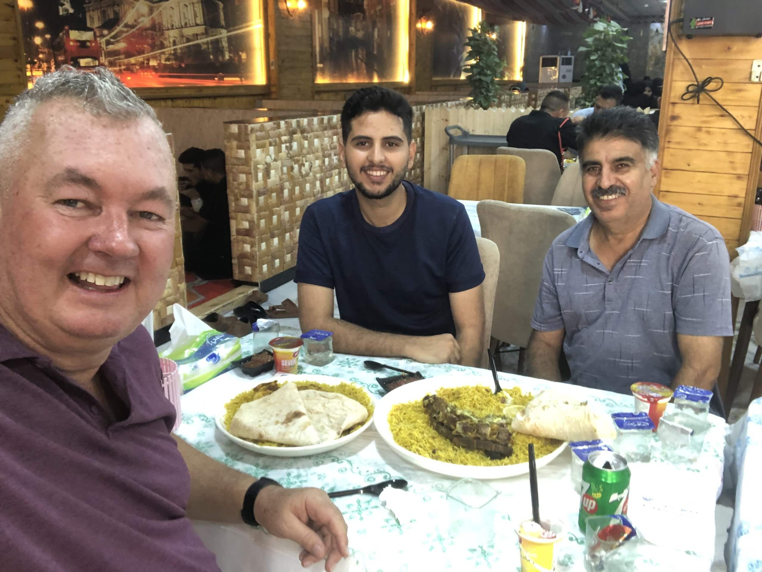 Sharing a typical Iraqi lunch of rice and goat with Fahad and his uncle in a restaurant in Hillah.