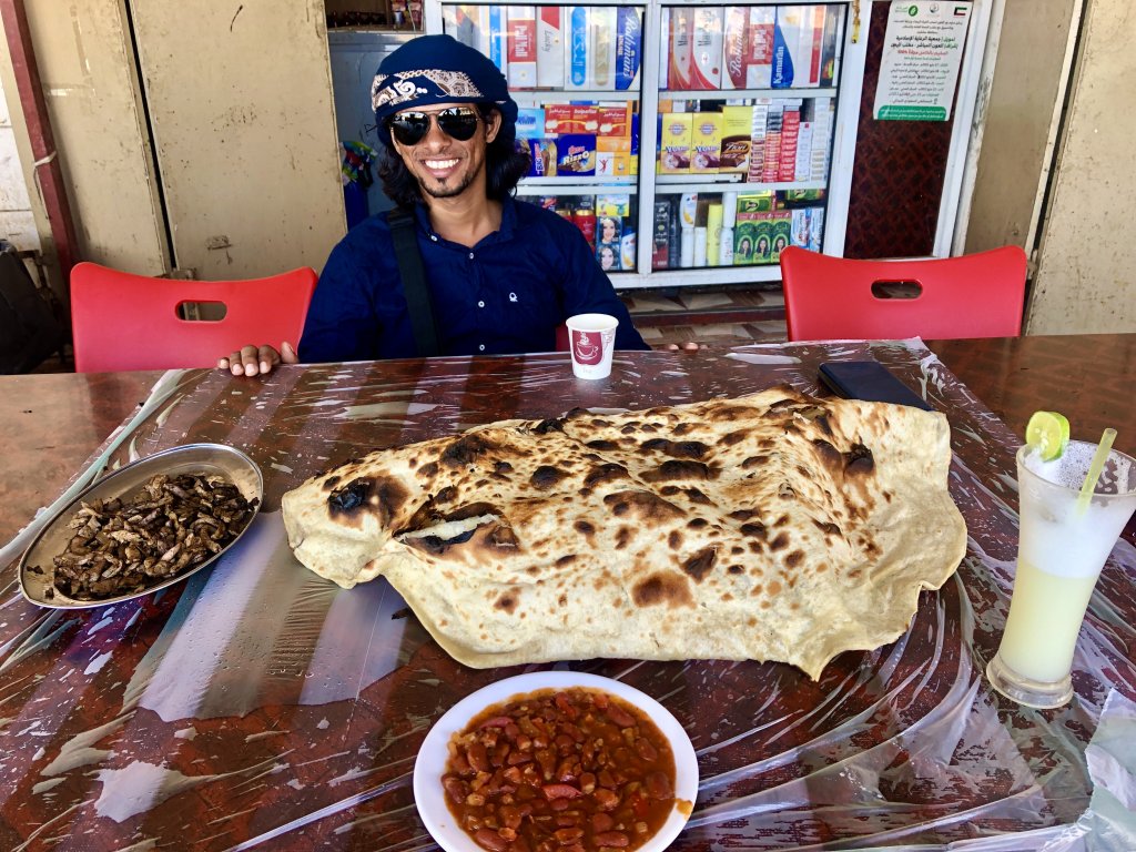 Sharing breakfast, and the largest piece of flatbread I've ever seen, at the Shabwah restaurant with my guide Ali.