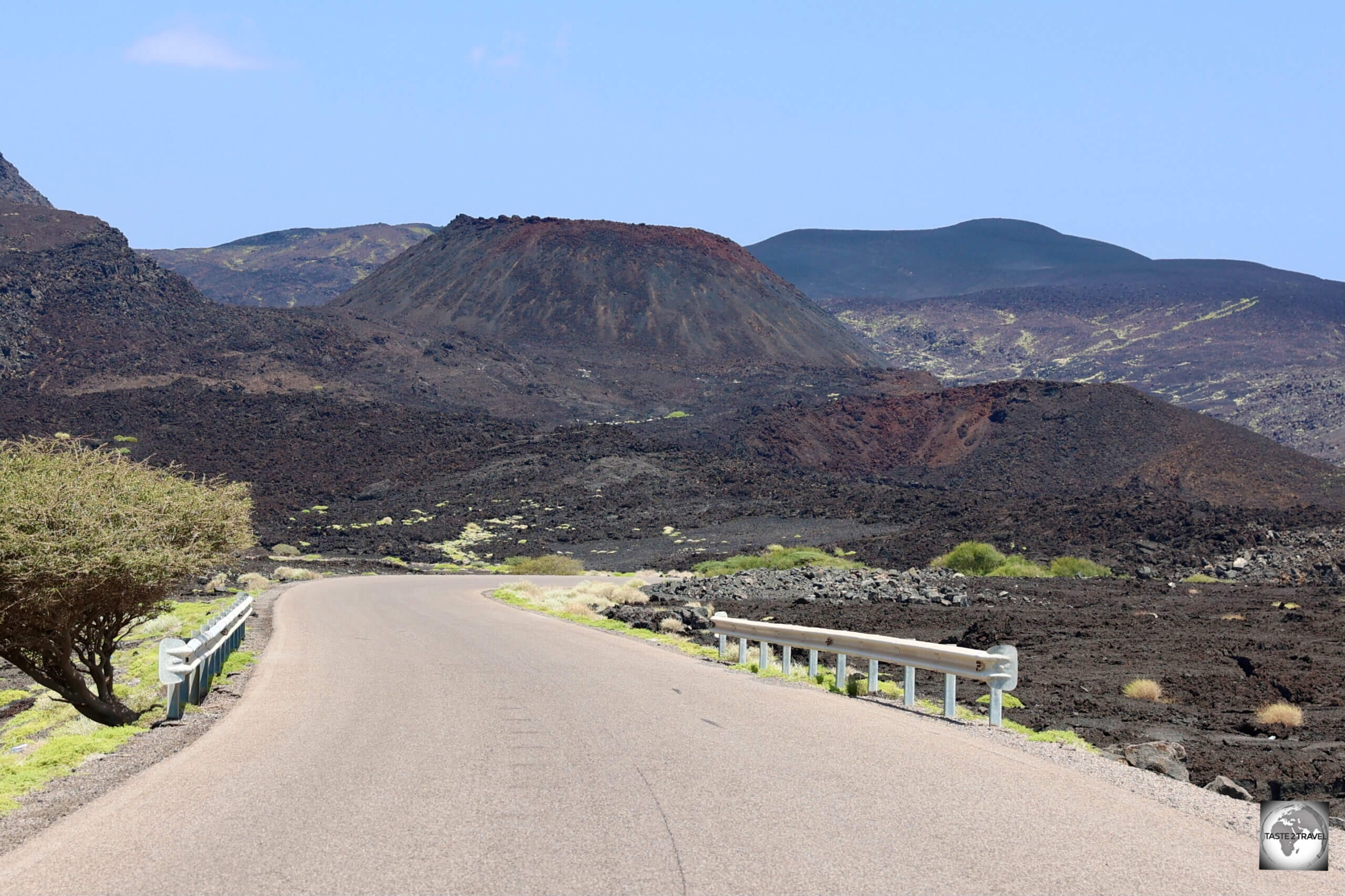 The road through the Ardoukoba volcanic lava field winds its way past recently erupted volcanoes and around basaltic lava flows.