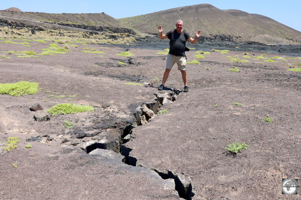 Straddling a tectonic divide with one foot on the Africa plate and one on the Arabian plate.