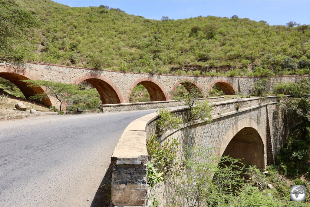 An out-of-use railway viaduct lies alongside the Asmara to Massawa highway.