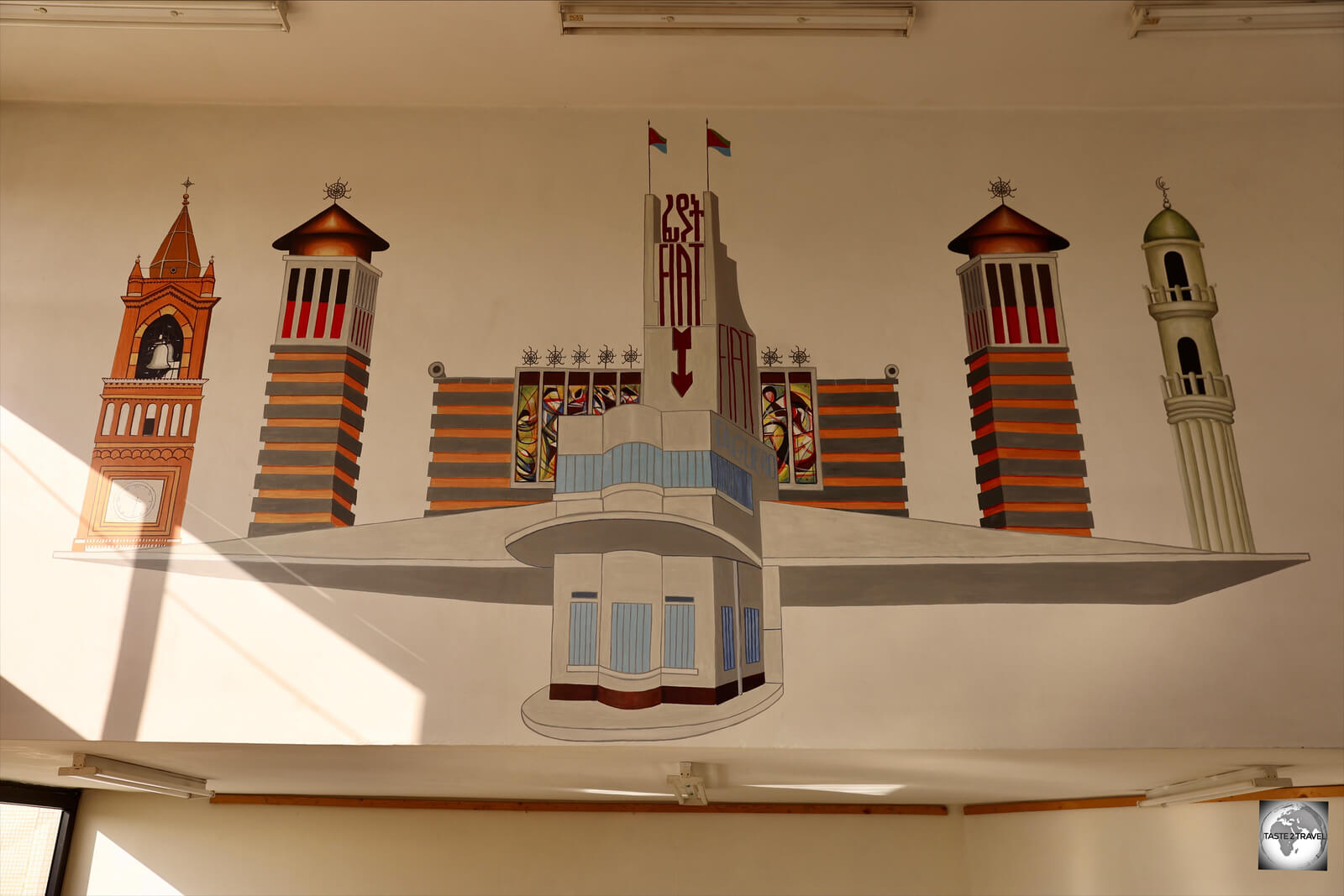 Artwork, showcasing the iconic buildings of Asmara, adorns the office wall at Damera Tours.