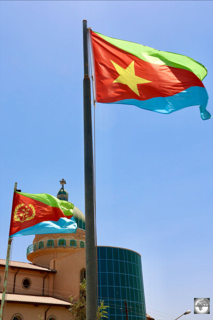The Eritrean flag, flying alongside the flag of the Eritrean People's Liberation Front in the city of Keren.