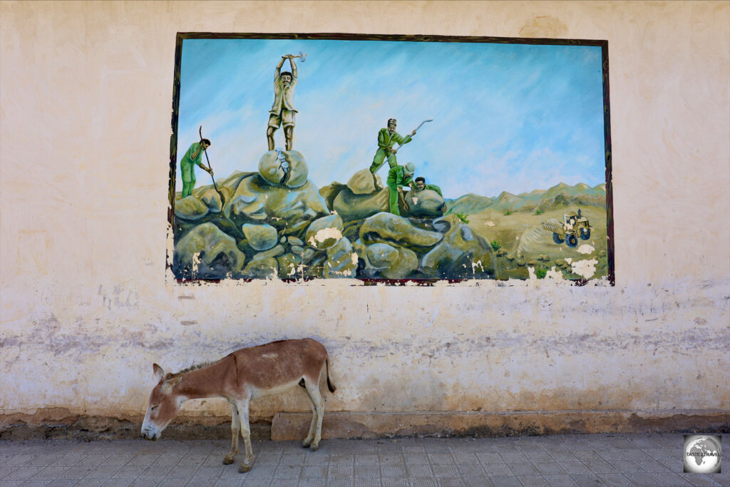 Revolutionary artwork, and a lazy donkey, in downtown Keren.
