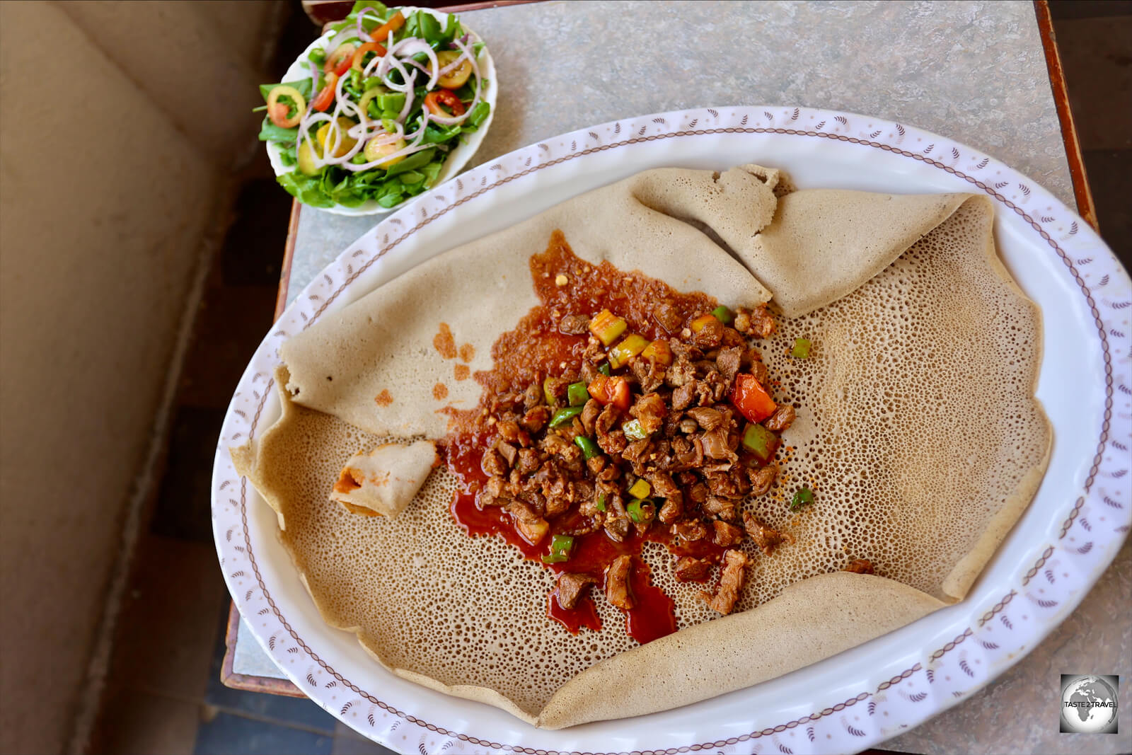 Always eaten by hand, Injera is often served with a spicy goat stew.