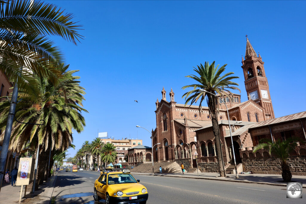 A view of Harnet street, the main street of Asmara, with Asmara cathedral in the background.