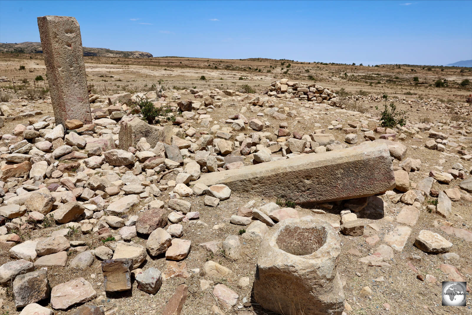 Carved stones from an ancient temple lie in wait, ready for archeological investigations.