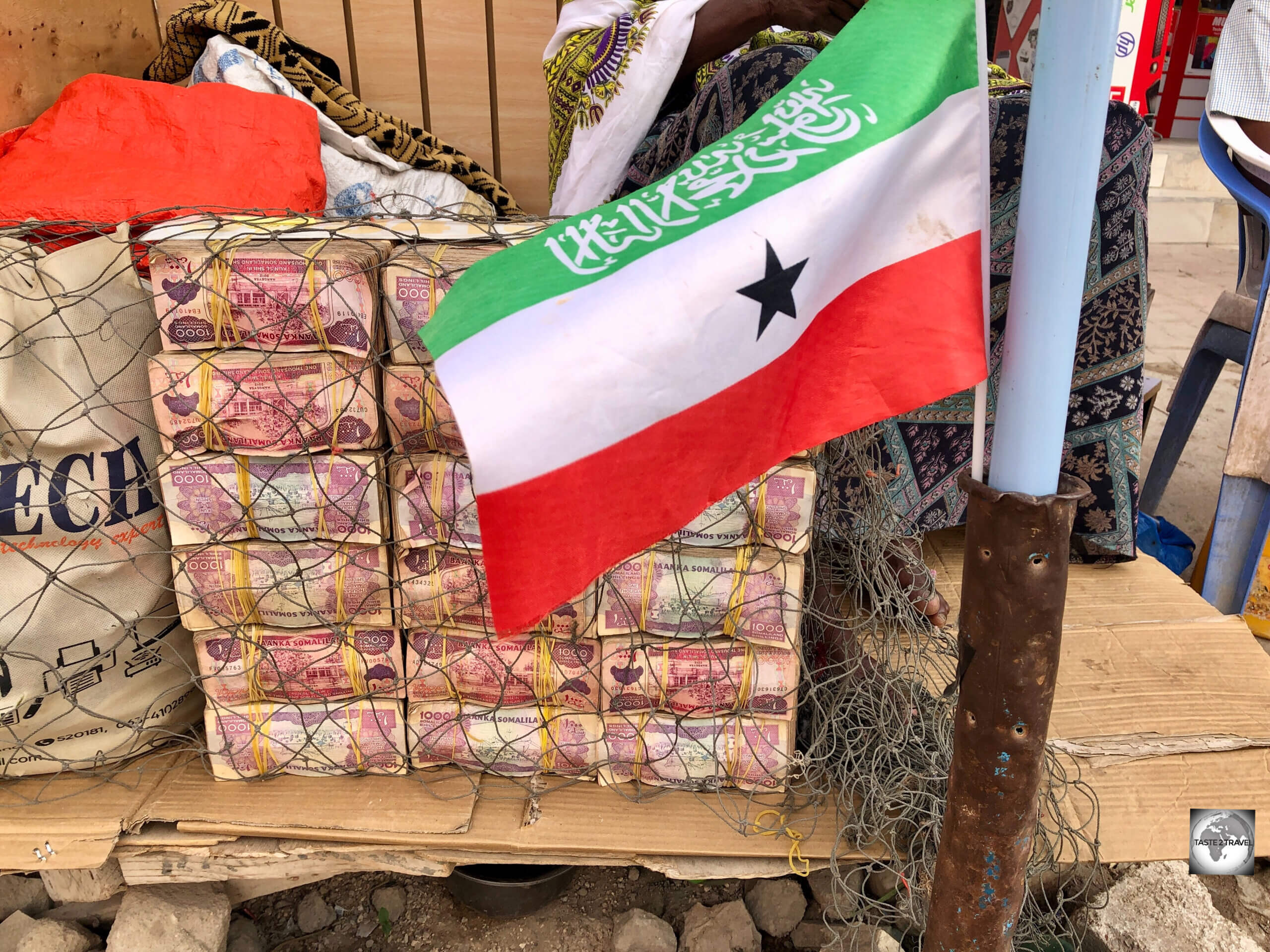 The flag of Somaliland, flying in front of a wall of Somaliland shillings, at a money exchange in Hargeisa.