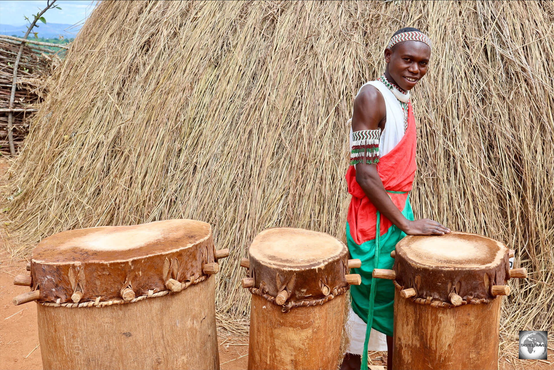 A Gishora Royal Drummer, and a selection of drums, alongside the Royal Palace.